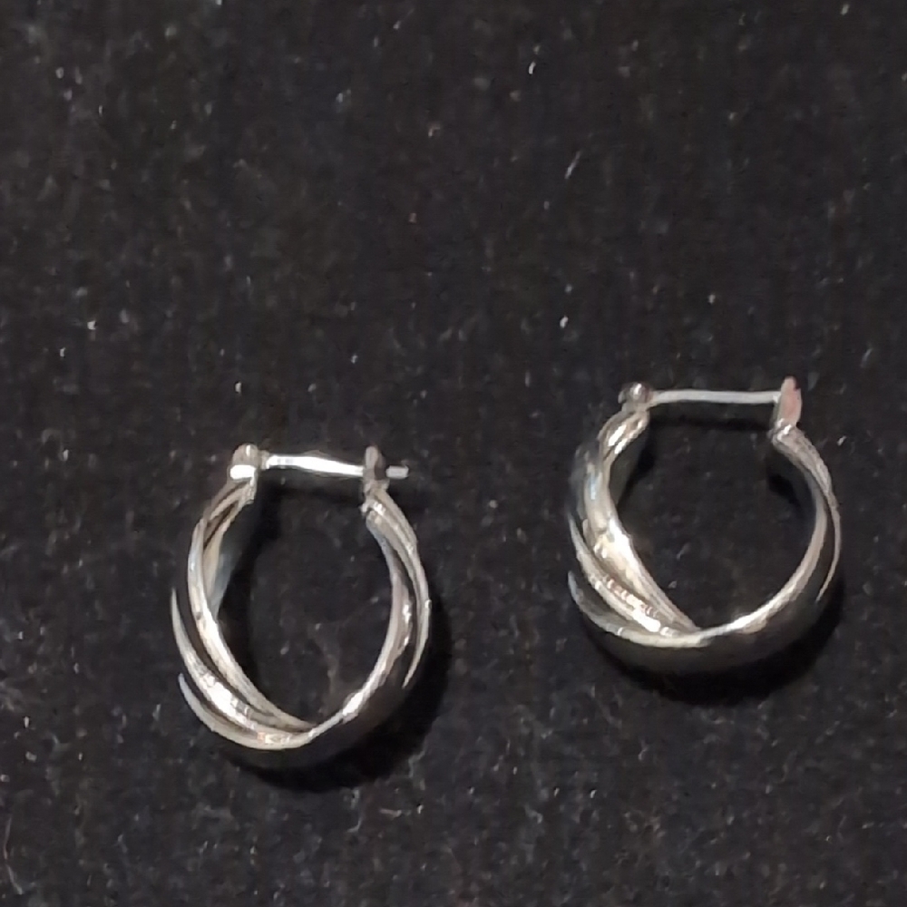 silver-plated, twisted hoop earrings with a latch closure.